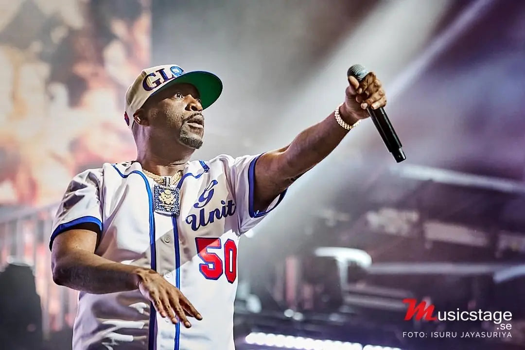 tony yayo on stage with a microphone at the ceiling