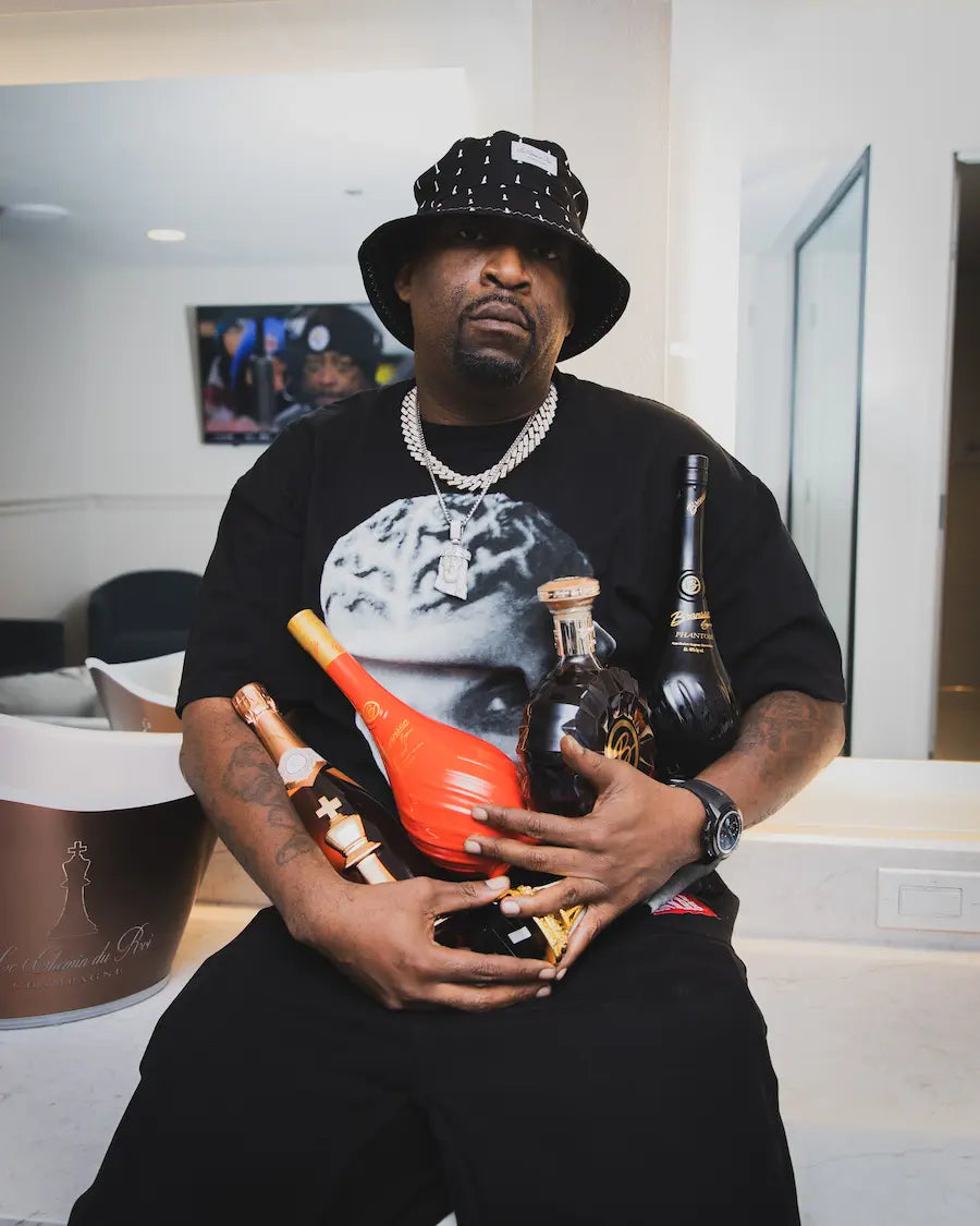 Tony Yayo with bottles of spirit
